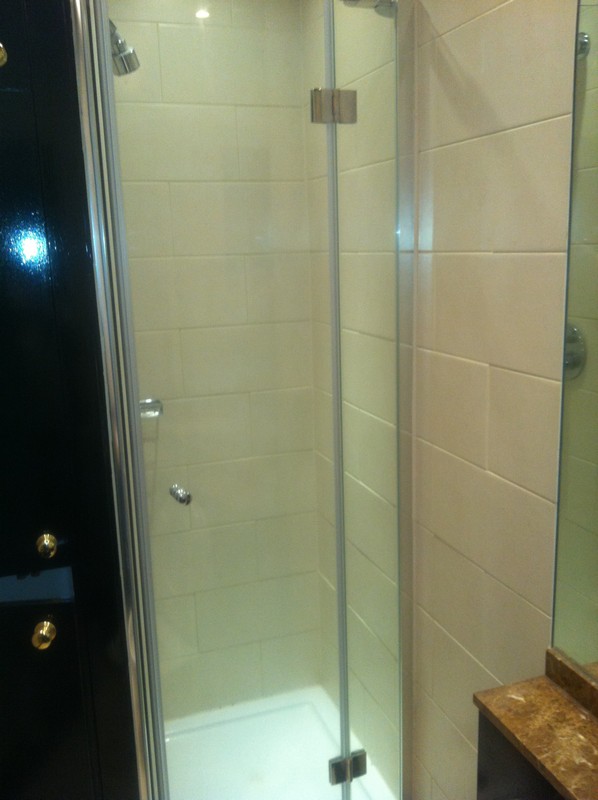 Frameless glass shower enclosure with chrome fittings in Hampton